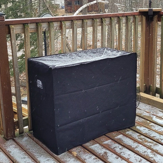 Cedar Planters winter cover with snow cover on a wooden deck during a snowfall.
