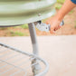Pearl White elevated metal garden bed with wheels and self watering system zoomed in on the handle used to help roll the garden bed. 