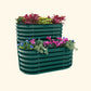 A british green cascading metal Garden Bed with colorful flowers and plants on a white background.