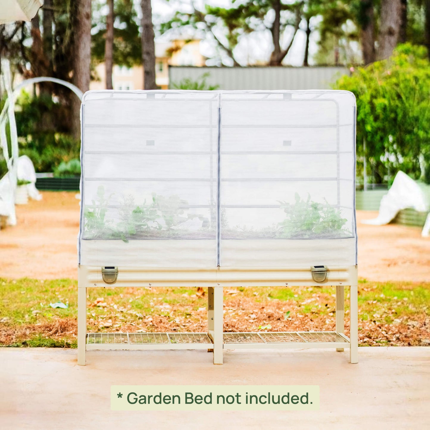 White metal garden bed with mesh cover in a garden setting with text clarifying the garden bed is not included.