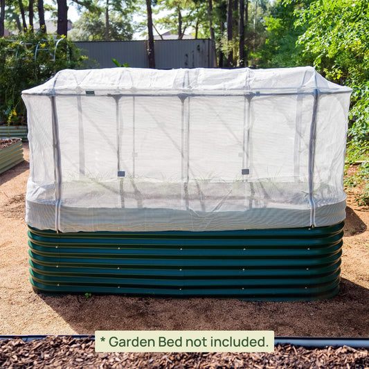 Mesh cover system installed on british green raised garden bed in a backyard.