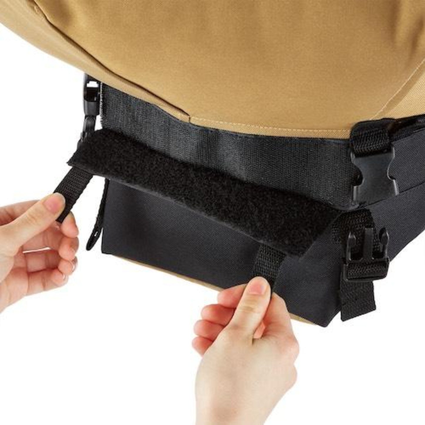 Close-up of a person adjusting the compost bag attached to the bottom of an Urban Worm Bag on a white background. 