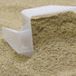 Close-up of Urban Worm Chow in a container next to a plastic scoop.